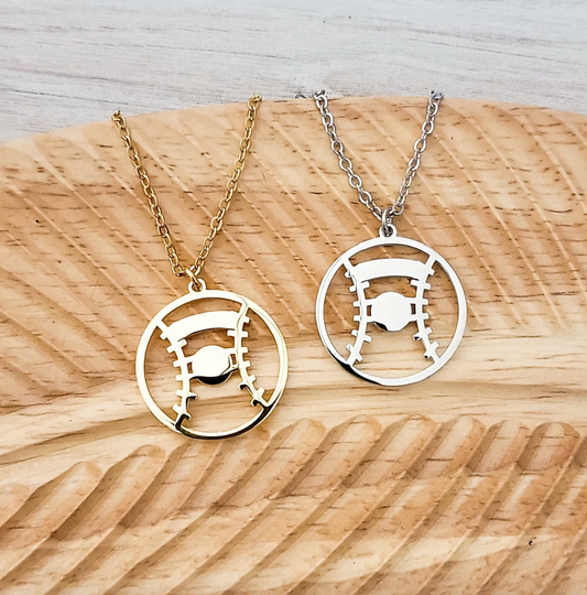 Two necklaces with circular pendants on a wooden surface